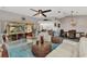 Open-concept living room featuring tile floors, white furniture and glass doors to the lanai at 3058 Curry Ter, Port Charlotte, FL 33981