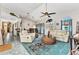 Open-concept living room with tile floors, arched windows, and access to the dining room and kitchen at 3058 Curry Ter, Port Charlotte, FL 33981
