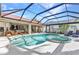 A spacious screened-in pool and hot tub area offers privacy and outdoor enjoyment at 3058 Curry Ter, Port Charlotte, FL 33981