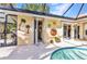 A serene outdoor living space with decorative touches, a pool, and easy access to indoor spaces at 3058 Curry Ter, Port Charlotte, FL 33981