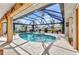 Enclosed pool area with mature landscaping at 3058 Curry Ter, Port Charlotte, FL 33981