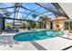 Screened in pool featuring a built-in jacuzzi and sun loungers for relaxation at 3058 Curry Ter, Port Charlotte, FL 33981