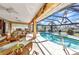 Inviting screened-in pool and spa with a spacious deck, perfect for outdoor relaxation and entertainment at 3058 Curry Ter, Port Charlotte, FL 33981