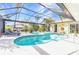 Backyard pool featuring a jacuzzi with a screened-in enclosure for privacy at 3058 Curry Ter, Port Charlotte, FL 33981
