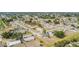 Expansive aerial view of a residential neighborhood featuring lush greenery and neatly arranged homes under a clear sky at 3342 Avanti Cir, North Port, FL 34287