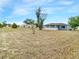 Backyard view of house with a screened in lanai and large yard at 3342 Avanti Cir, North Port, FL 34287