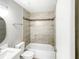 Bathroom boasts tub and shower combo, tiled walls, modern fixtures, and bright lighting at 3342 Avanti Cir, North Port, FL 34287