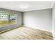 Bright bedroom features a window view, modern ceiling fan, and lovely wood-look flooring at 3342 Avanti Cir, North Port, FL 34287