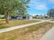 Charming blue home with well-maintained lawn and landscaping, with inviting curb appeal and a sunny atmosphere at 3342 Avanti Cir, North Port, FL 34287