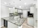 Bright, updated kitchen with white cabinetry, granite counters, pendant lighting and stainless steel appliances at 3342 Avanti Cir, North Port, FL 34287