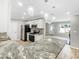 Bright, modern kitchen with granite countertops, white cabinets and stainless appliances, with open access to the living area at 3342 Avanti Cir, North Port, FL 34287