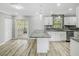 Modern kitchen featuring white cabinets, granite countertops, stainless steel appliances, and a large island at 3342 Avanti Cir, North Port, FL 34287