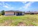 Expansive backyard featuring a screened patio and lush green space at 3647 Culpepper Ter, North Port, FL 34286