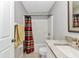 Bathroom featuring a shower-tub, sink, toilet, framed mirror and a towel rack at 3647 Culpepper Ter, North Port, FL 34286