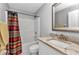 Bathroom featuring a shower-tub, sink, toilet, framed mirror and a towel rack at 3647 Culpepper Ter, North Port, FL 34286