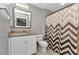 Bathroom featuring a sink, toilet, decorative shower curtain, and a framed mirror at 3647 Culpepper Ter, North Port, FL 34286