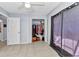 Bedroom featuring tile flooring, a closet with open doors, and dark curtains at 3647 Culpepper Ter, North Port, FL 34286