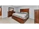 A primary bedroom featuring a hardwood bed frame, dresser with mirror, and tile flooring at 3647 Culpepper Ter, North Port, FL 34286