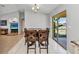 Open-concept dining area with access to the living room and a view of the backyard at 3647 Culpepper Ter, North Port, FL 34286