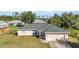Charming home boasts a new roof, lush lawn, and an attached two-car garage for easy parking at 3647 Culpepper Ter, North Port, FL 34286