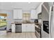Bright kitchen features white cabinets, stainless steel appliances, and granite countertops for a modern touch at 3647 Culpepper Ter, North Port, FL 34286