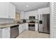Modern kitchen showcases stainless steel appliances, white cabinets, and ample counter space at 3647 Culpepper Ter, North Port, FL 34286