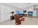 Inviting living room with leather recliner, tile floors, and a ceiling fan for comfortable living at 3647 Culpepper Ter, North Port, FL 34286