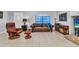 Spacious living room with leather furniture, tile flooring, and natural light creates a welcoming space at 3647 Culpepper Ter, North Port, FL 34286