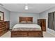 Comfortable bedroom featuring a stylish wood headboard, ceiling fan, and ample storage with dressers at 3647 Culpepper Ter, North Port, FL 34286