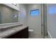 Modern bathroom featuring a granite countertop vanity and a glass-enclosed walk-in shower at 432 Gun Cay Ln, Punta Gorda, FL 33950