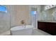 Modern bathroom with soaking tub and wood grain cabinets at 432 Gun Cay Ln, Punta Gorda, FL 33950