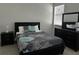 Comfortable bedroom featuring a stylish bed with floral accents, nightstand and dresser set at 432 Gun Cay Ln, Punta Gorda, FL 33950