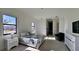 Bright bedroom with large windows, neutral furniture, and doorway to hall at 432 Gun Cay Ln, Punta Gorda, FL 33950