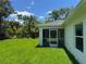 The screened-in lanai overlooks the lush, green backyard and landscaping at 4754 Caputo Ave, North Port, FL 34288