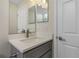 Bathroom vanity featuring single sink, quartz counters, grey cabinets, and modern fixtures at 4754 Caputo Ave, North Port, FL 34288