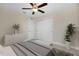 Bedroom features neutral walls, ceiling fan, and double door closet for storage at 4754 Caputo Ave, North Port, FL 34288