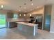 Modern kitchen with gray cabinets, quartz countertops, and stainless steel appliances at 4754 Caputo Ave, North Port, FL 34288