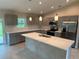 Spacious kitchen featuring gray cabinets, white countertops, and stainless steel appliances at 4754 Caputo Ave, North Port, FL 34288