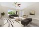 Bright living room featuring tile floors, modern furnishings, and a large window at 4754 Caputo Ave, North Port, FL 34288