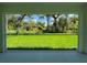 A screened-in patio displays a manicured lawn with lush foliage at 4754 Caputo Ave, North Port, FL 34288