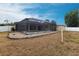 Backyard with pool, gravel landscaping, and vinyl perimeter fence at 4788 Abadan St, North Port, FL 34287