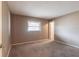Neutral bedroom features plush carpeting, a window for natural light, and a door to other rooms at 4788 Abadan St, North Port, FL 34287