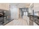 Kitchen with white cabinets, black granite countertops, and stainless steel appliances at 4788 Abadan St, North Port, FL 34287