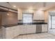Kitchen with white cabinetry, tile floors, and stainless steel appliances at 4788 Abadan St, North Port, FL 34287