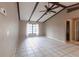 Bright living room features tiled floors and vaulted ceiling with beams at 4788 Abadan St, North Port, FL 34287