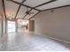 Large living room featuring tiled floors and vaulted ceiling with beams at 4788 Abadan St, North Port, FL 34287