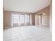 Spacious living room with tile floors, neutral walls, and bright natural lighting at 4788 Abadan St, North Port, FL 34287