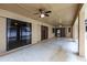 Empty covered patio features ceiling fans and sliding doors leading to the home's interior at 4788 Abadan St, North Port, FL 34287