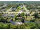 Serene aerial view showcasing a home with water access, lush greenery, and peaceful neighborhood surroundings at 485 Dorchester St, Port Charlotte, FL 33954