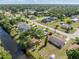 Aerial shot featuring a well-situated home near waterways and lush greenery at 485 Dorchester St, Port Charlotte, FL 33954
